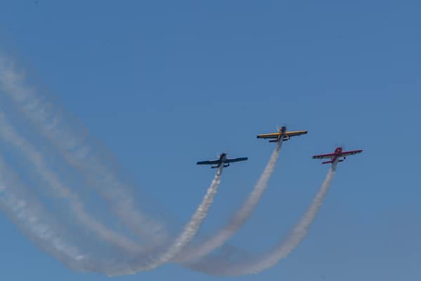 Aerobatic planes fly at a previous year's Wings & Waves