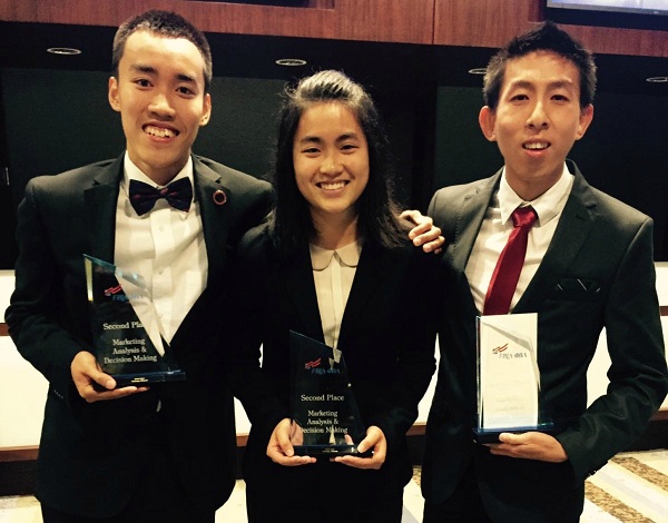 Nghia "Nicky" Ho, Brenda Lim and Milton Tan display their awards.