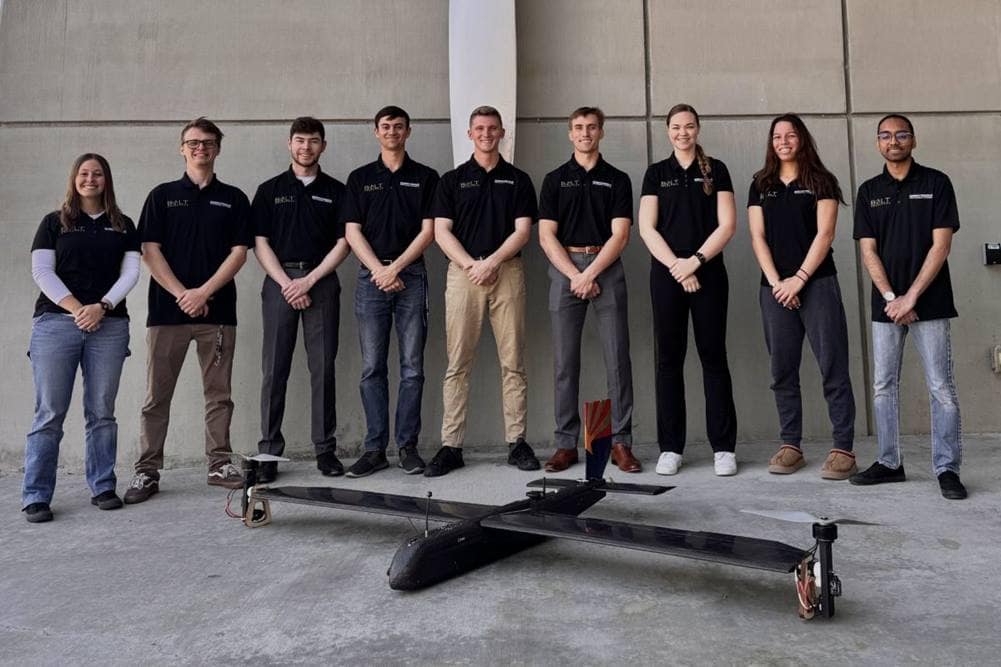 Embry-Riddle Prescott’s BOLT Aerospace team stands with their Design-Build-Vertical-Flight project, CARLOS (Craft for Aerial Relocation of Light Objects and Supplies)