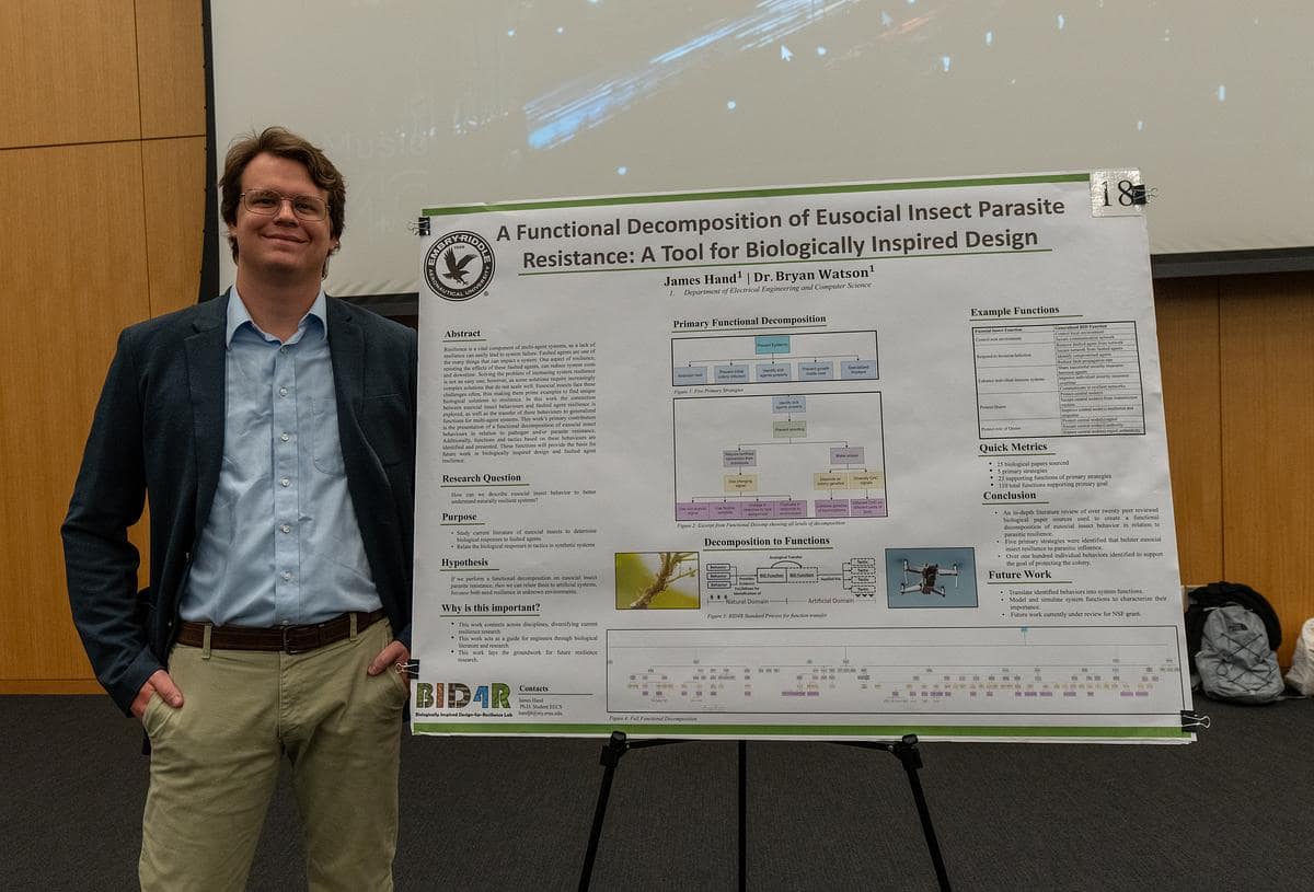James Hand, an Electrical Engineering and Computer Science doctoral student, won first place overall for his graduate poster, which details research on how insect colony behaviors can be used as a tool for engineering.