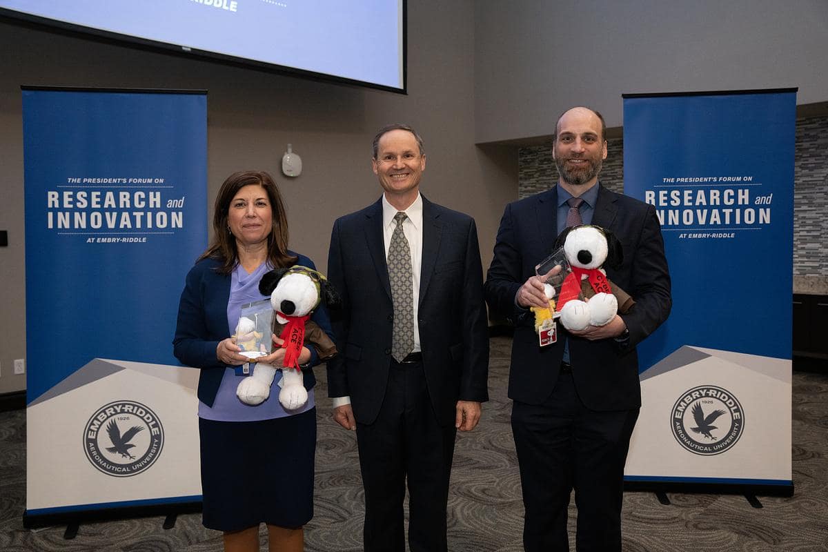 Aerospace Cybersecurity Excellence (ACE) award-winners Luci Holemans and Stefan Schwindt flanked Embry-Riddle's Center for Aerospace Resilient Systems executive director, Dan Diessner