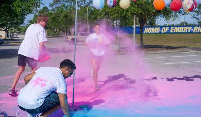 A student participates in Eta Iota’s annual 5K color run