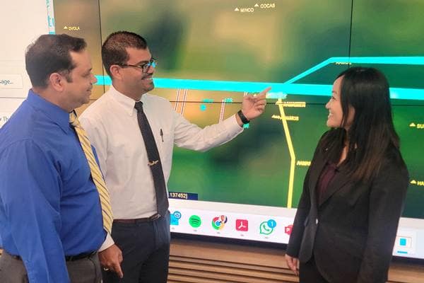 Research team members Carlos Castro Peña, Dr. Victor Fraticelli Rivera and Sakurako Kuba examine a mock-up of departure/arrival corridors