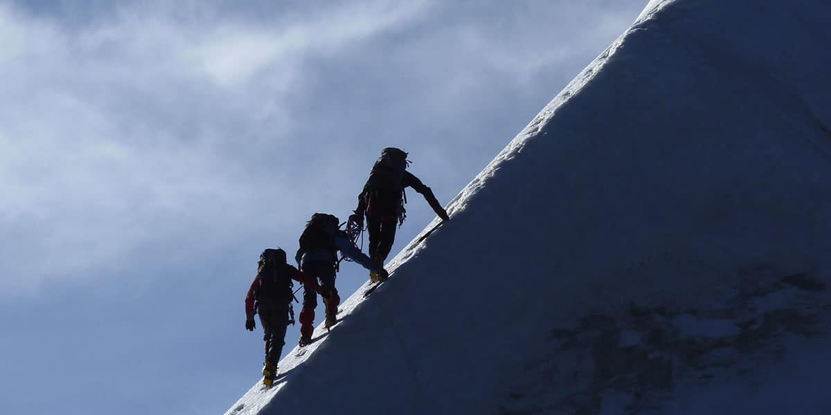 climbers ascending a mountain