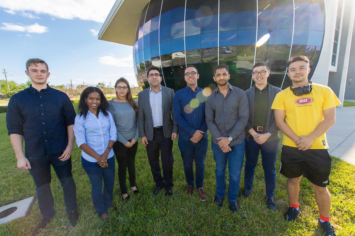 From Left: Lee Alacoque, Rossana Fernandes, Patricia Velasoc, Dr. Ali Tamijani, Dr. Kaveh Gharibi (post-doctoral researcher), Chitrang Patel and Zichao Wang, in front of Embry-Riddle’s MicaPlex research facility. (Photo: Embry-Riddle/David Massey)