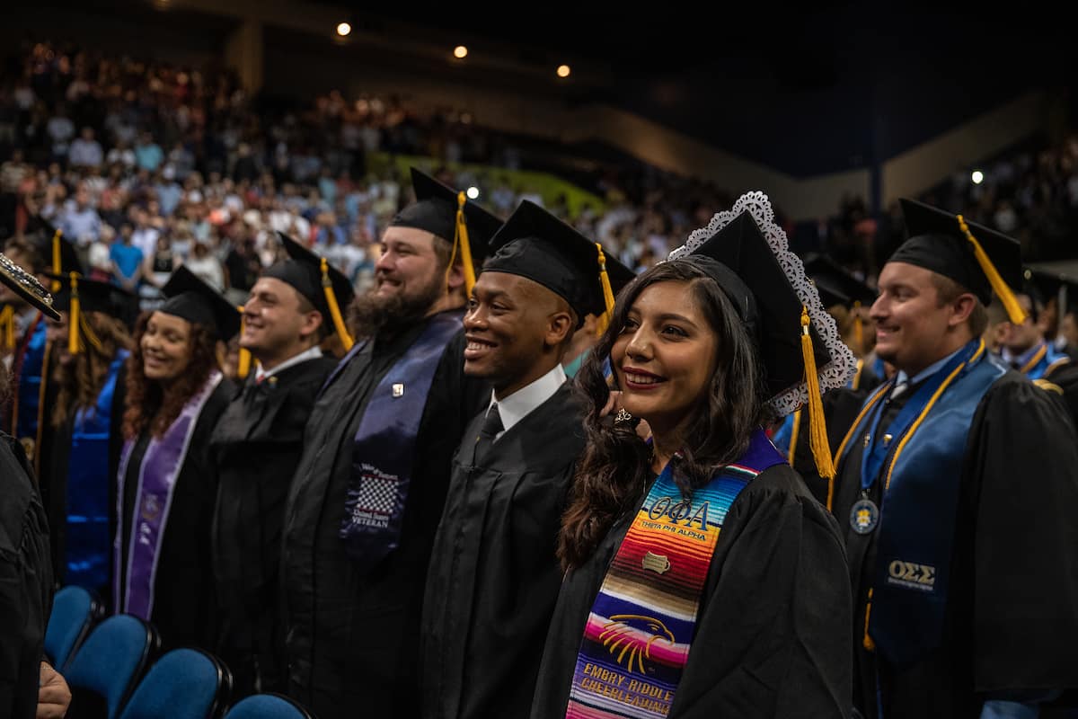Students stand at an Embry-Riddle Graduation in Daytona Beach.
