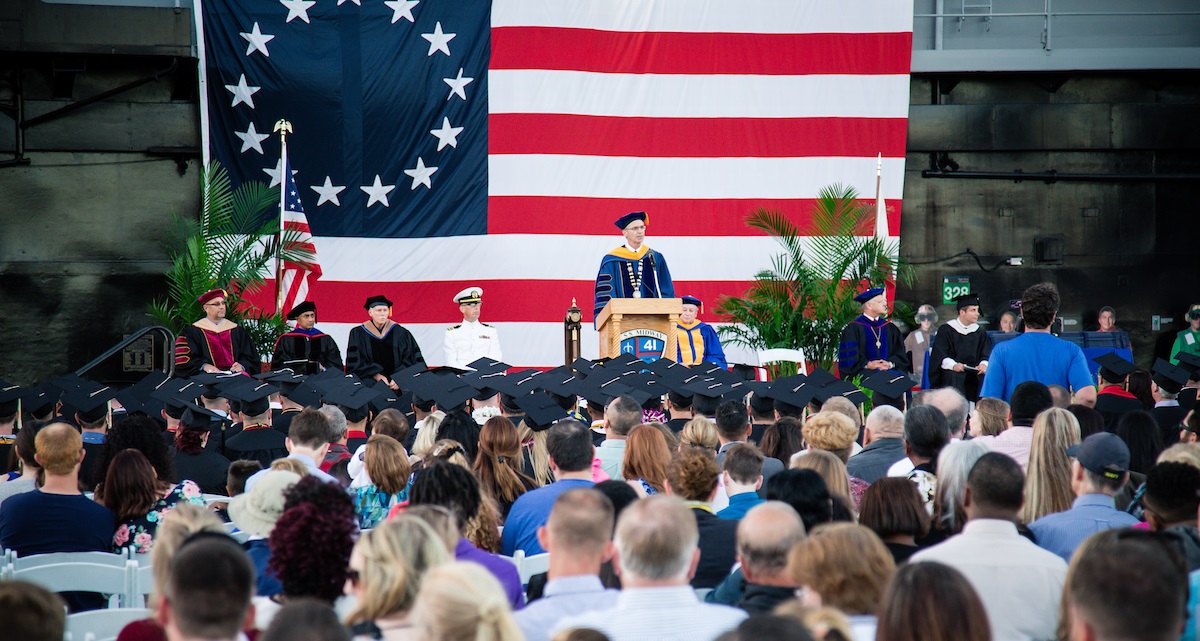 President P. Barry Butler addresses the graduating class at the 2017 San Diego Campus commencement ceremony, held aboard the USS Midway Museum. (Photo: Embry-Riddle/Jason Kadah)