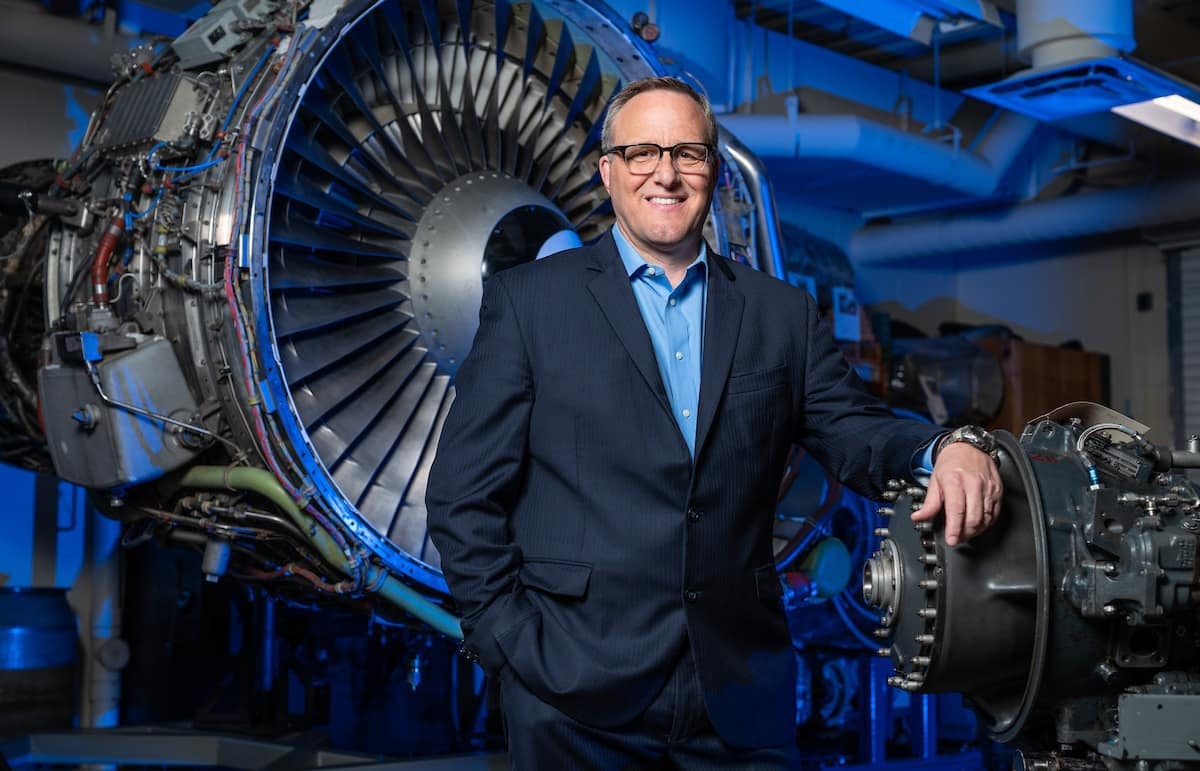 R. Eric Jones, associate professor and chair, Aviation Maintenance Science, in front of an engine