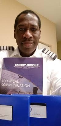 pilot Garfield McFarlane holds an embry-riddle pamphlet