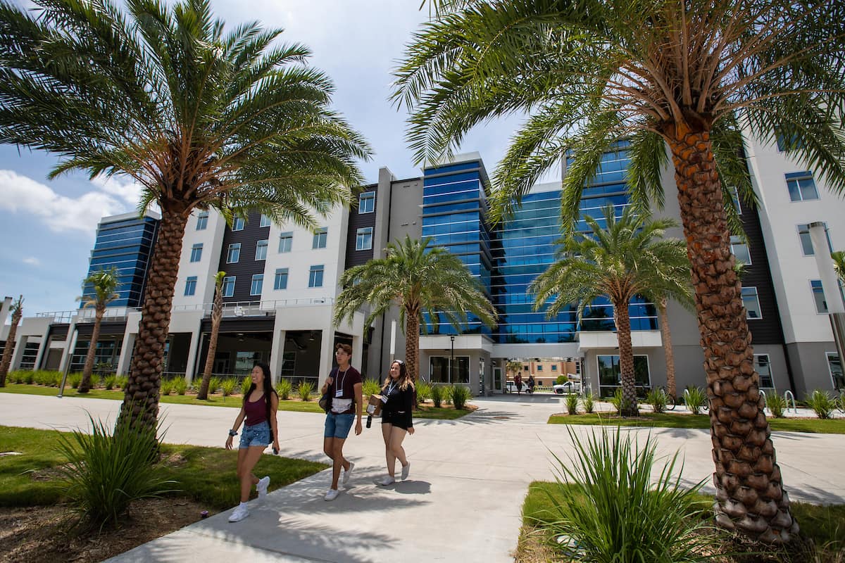 Students walk in front of the New Residence Hall 2
