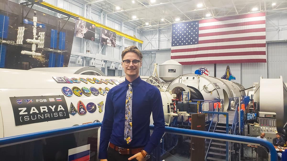 Spaceflight Operations senior Nicholas Lopac stands in the Vehicle Mockup Building, where astronauts train for new vehicles and the International Space Station, during a recent internship at NASA