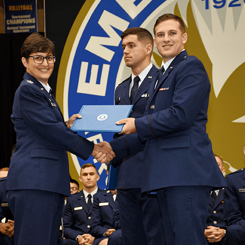 Col. Kimberley Ramos, left, at the AFROTC Commissioning Ceremony in May. Second Lt. Brandon Koury received distinguished graduate recognition.​