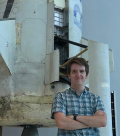 Noah Soderquist in front of a rocket.