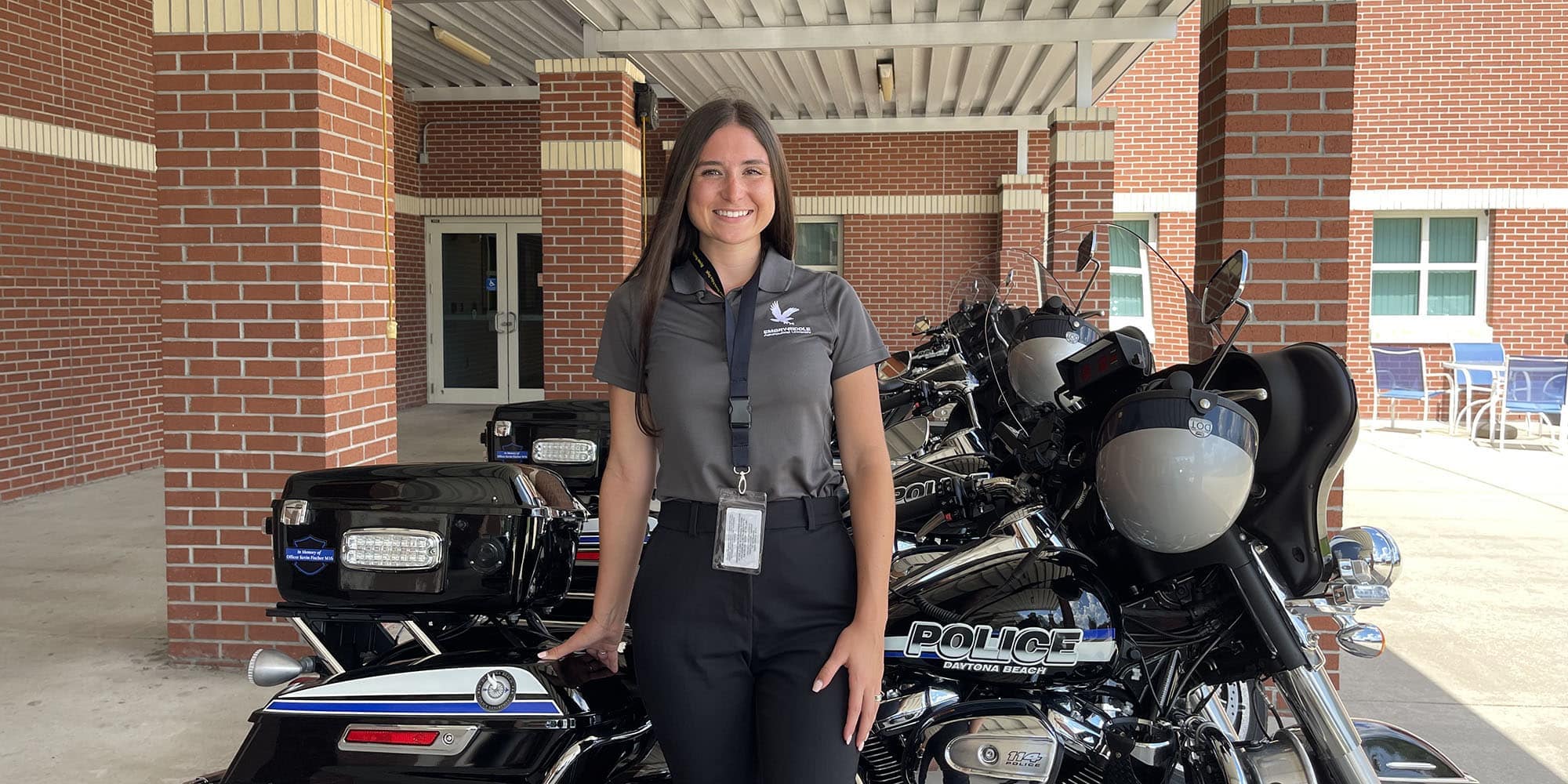 Photo of Hanna Wood standing by motorcycle