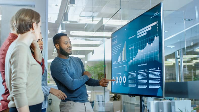 a group looks at data on a screen