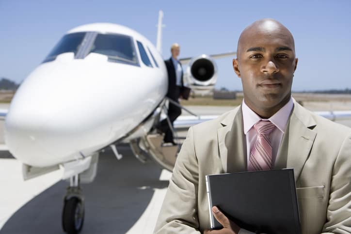 a man stands in front of an airplane