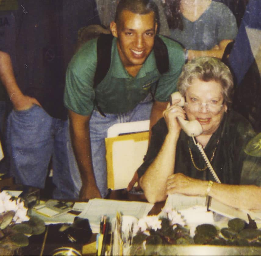 Old photo of Dottie Crawford on the phone with students in the background
