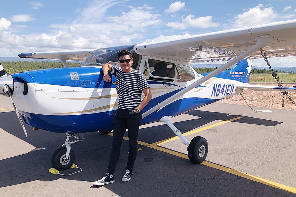 Student Khairul Afiq Zolkafli standing next to an ERAU Cessna