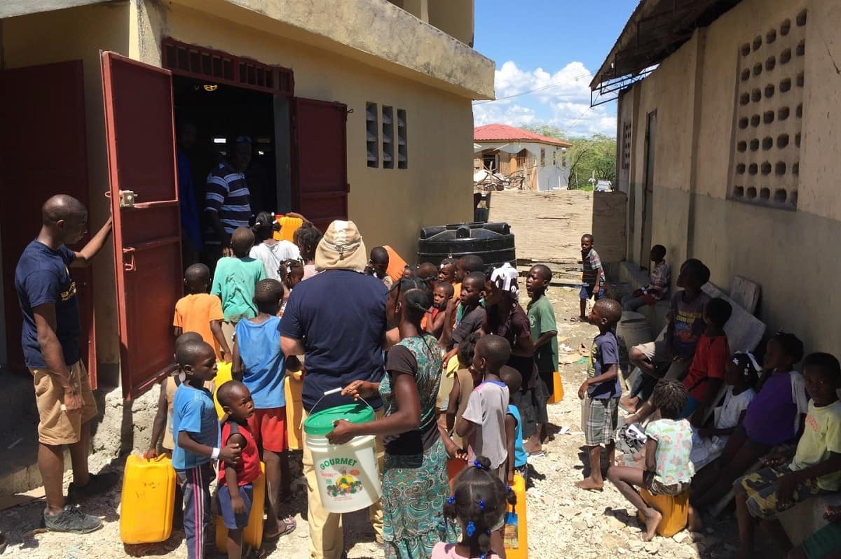 Students and faculty from Embry-RIddle talk with children in Haiti.