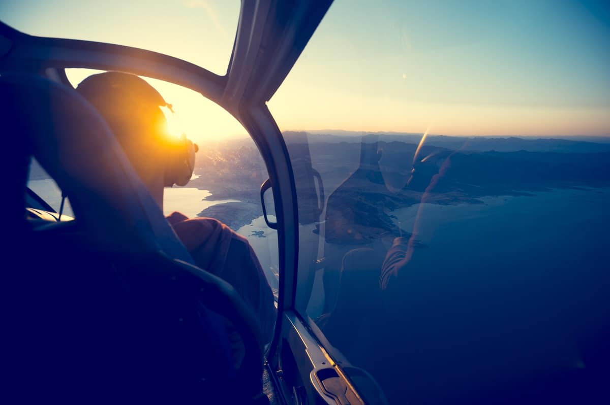 Behind the pilot from within a cockpit