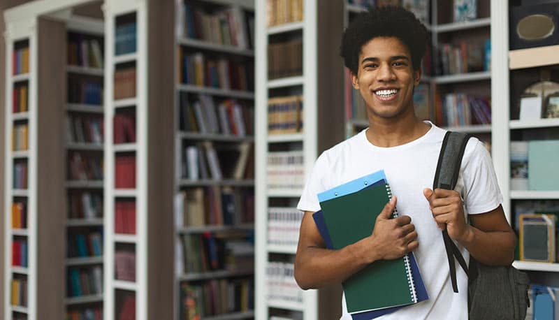 Male student carrying books