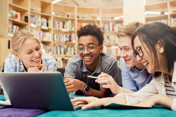 Students in library smiling