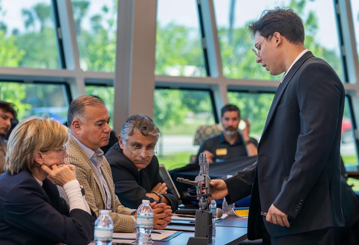 Winning Embry Riddle Aeronautical University’s 9th Launch Your Venture competition for entrepreneurs was Nick Cadavid, from Florida State University and founder of Morph Labs. Here, he shows judges his prototype of a prosthetic hand powered by brainwaves, which earned his startup the $10,000 grand prize.