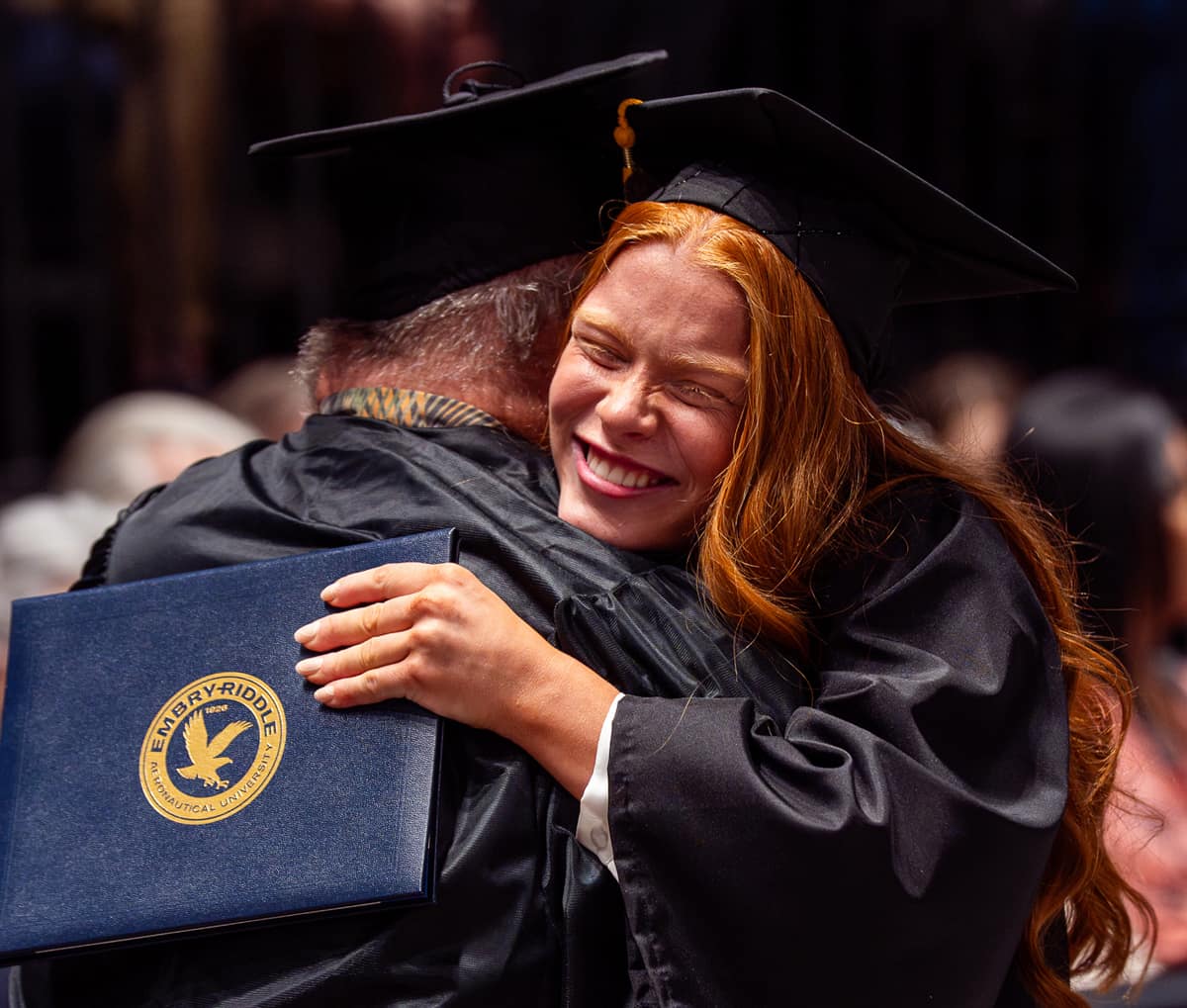 People hugging at Prescott graduation.
