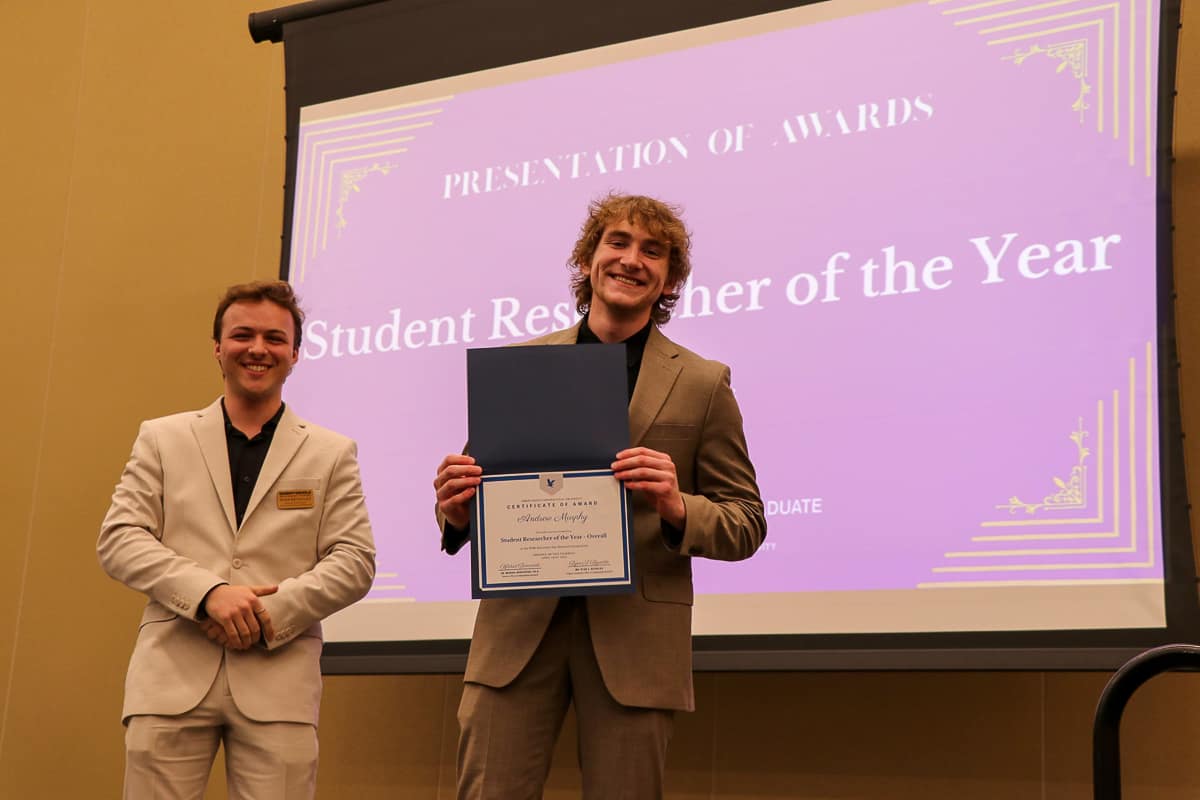 Man holding up certificate