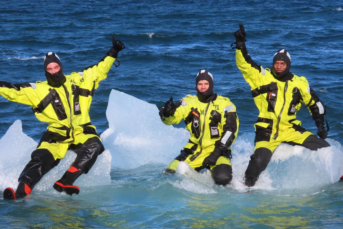 Students sit on icebergs in the arctic