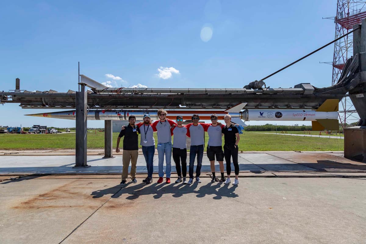 Students pose by a Nasa launch pad
