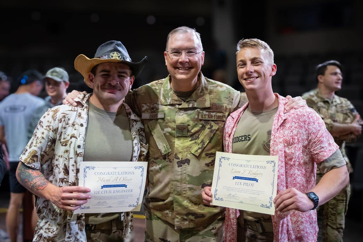 Detachment 028 Commander Col. Russell Davis celebrates with cadets Micah Oliver and Liam Rodgers during the unit’s Spring 2025 Drop Night event.
