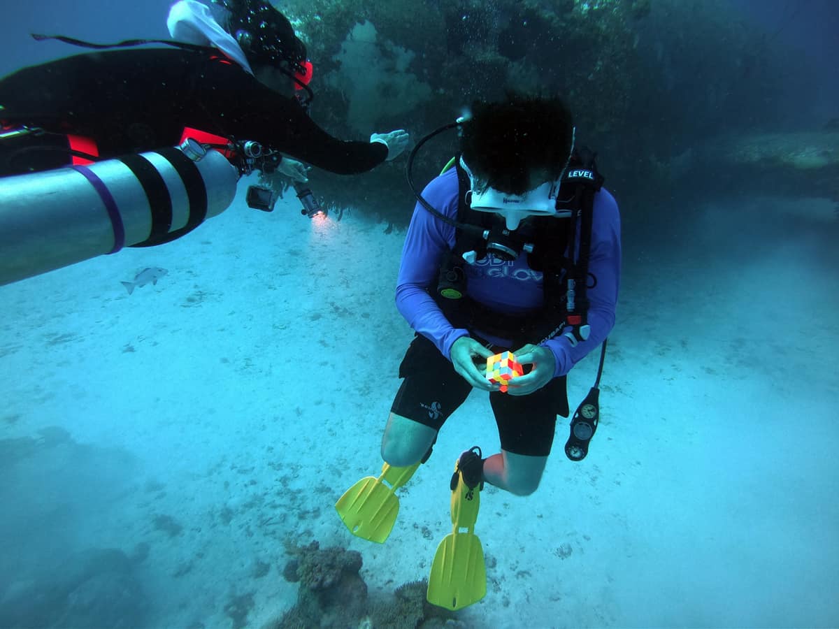 Nathan Graves solves a Rubik's Cube underwater at 100 meters of depth.