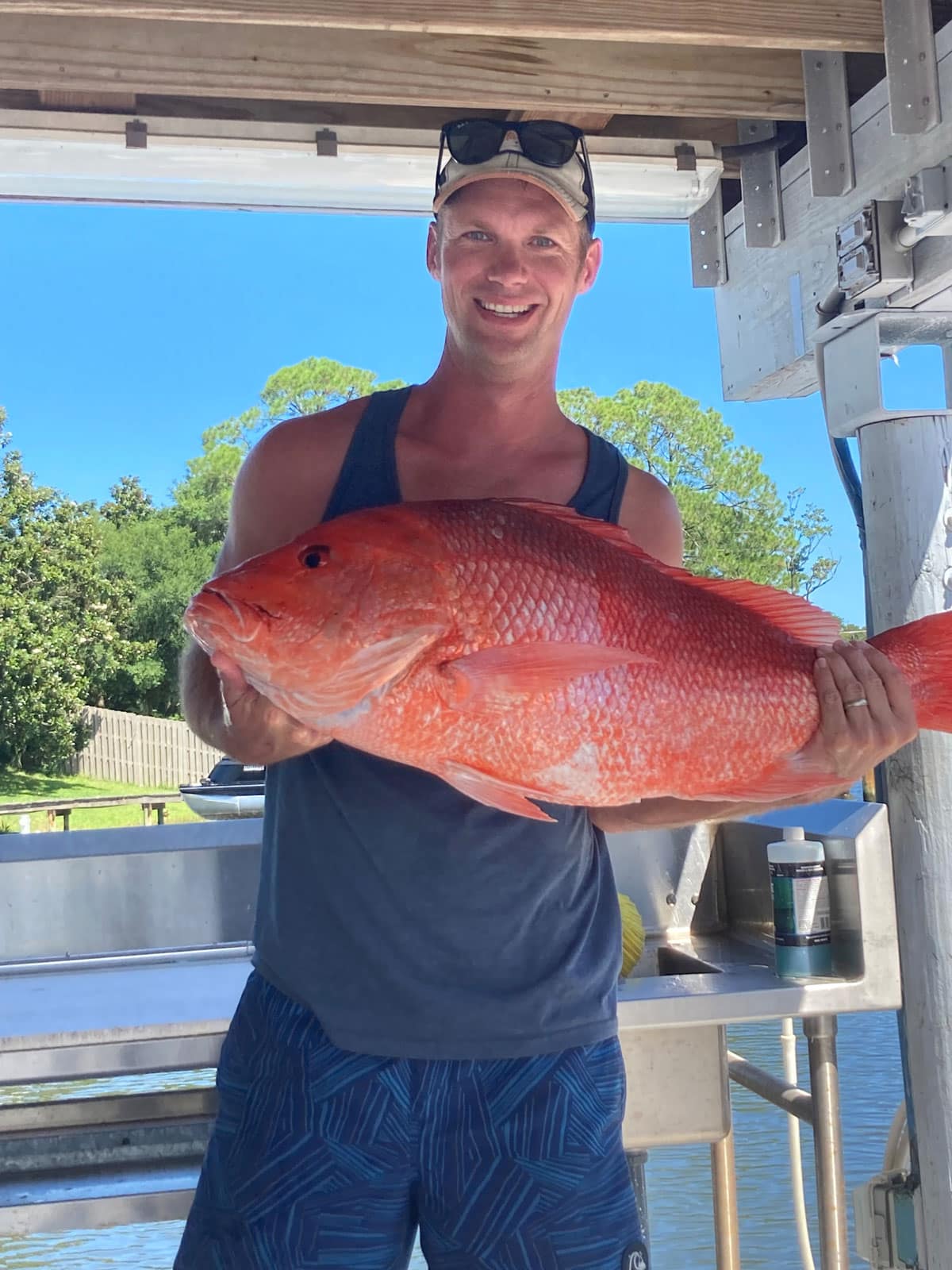 Man holding a red fish