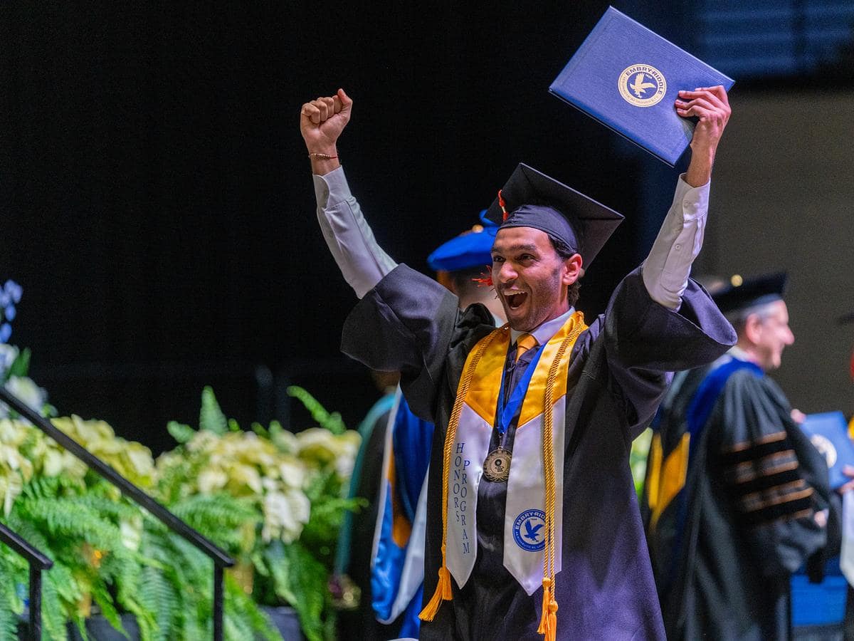 Graduate accepts diploma at Daytona Beach graduation.