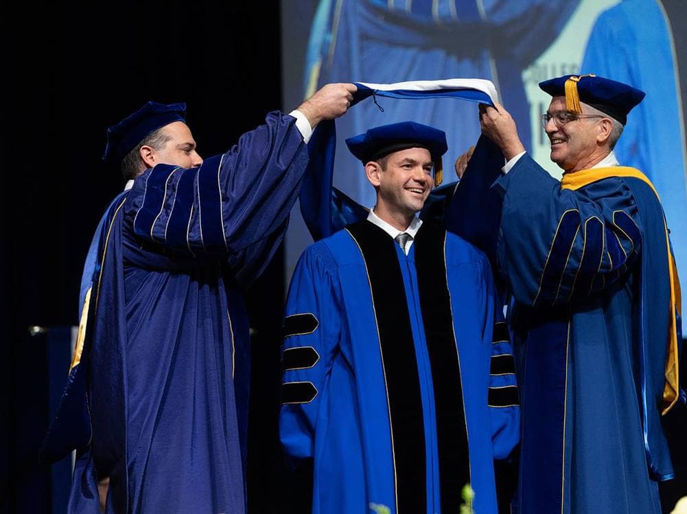 Jared Isaacman is joined on stage by Embry-Riddle President P. Barry Butler (right), Ph.D., and Dr. Kelly Austin (left), senior vice president for Academic Affairs and Provost