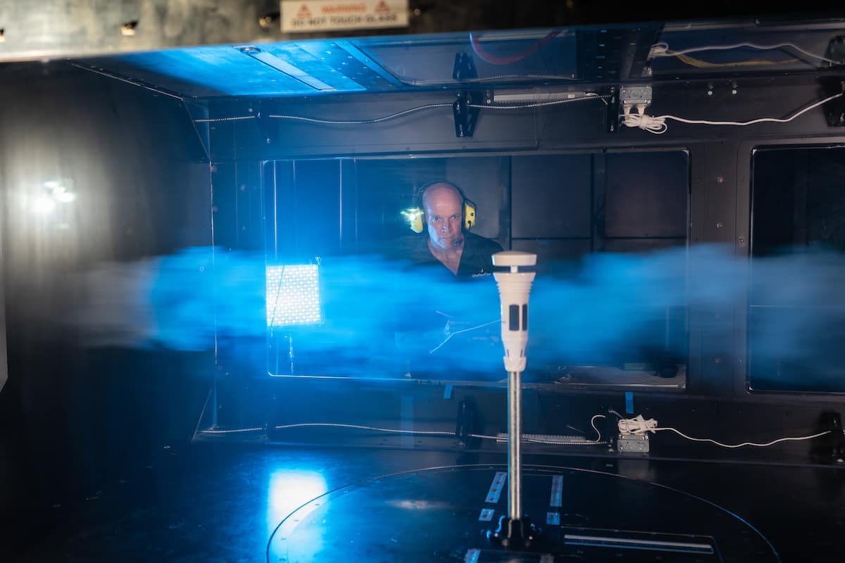 David St. John, WeatherFlow-Tempest co-founder and chief technology officer, affixes the Tempest weather station inside the Subsonic Wind Tunnel Facility at the Research Park