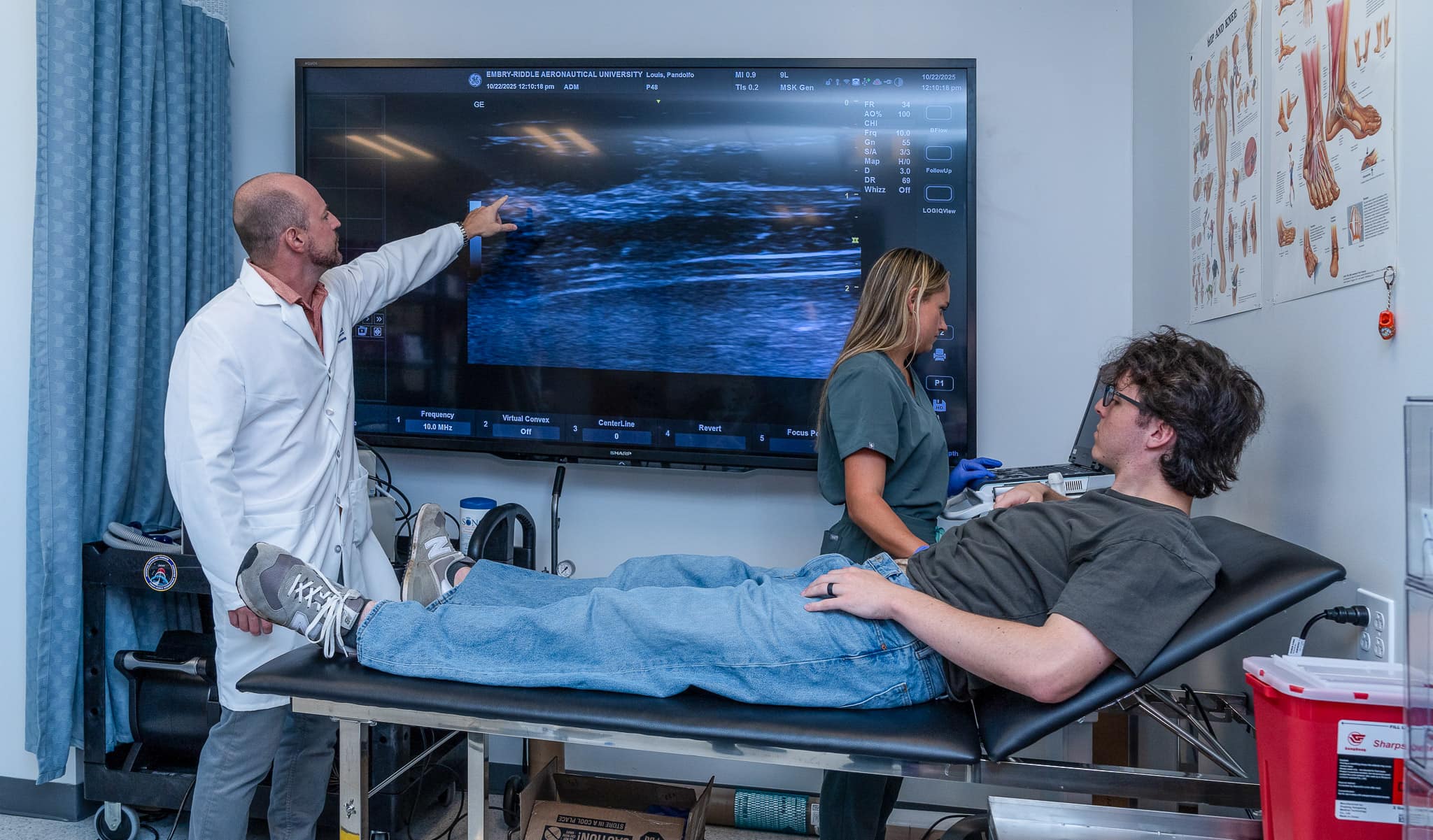 Dr. Scott Ferguson and Ph.D. candidate Sabrina Ehrenfort check the diaphragm thickness of a participant using Doppler ultrasound. The thickness of the diaphragm changes as the muscle strengthens through training.