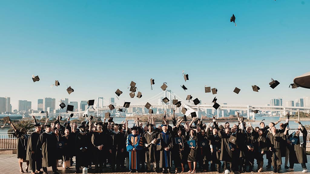 Graduates throw hats in the air