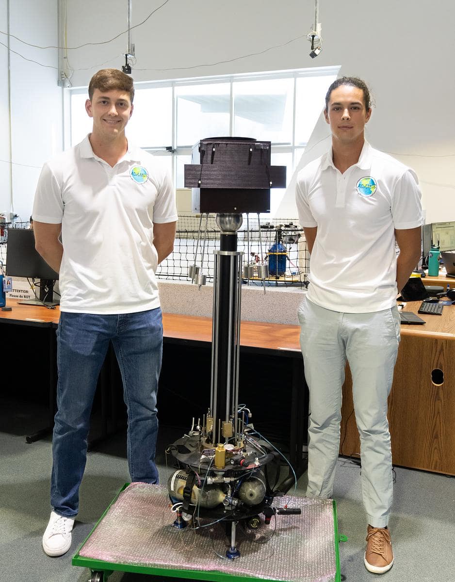 Aerospace Engineering seniors Spencer Johns and Pol Fontdegloria Balaguer stand with the LIDAR device