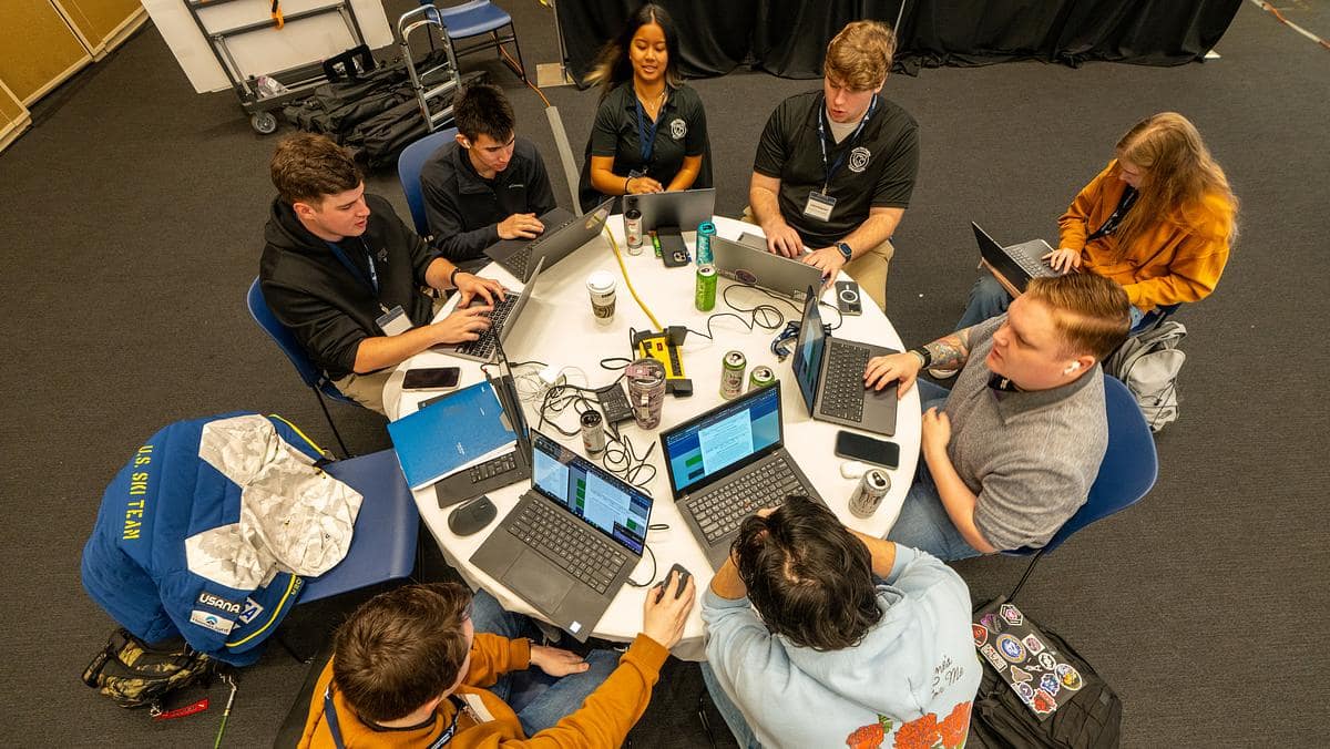 Students sit at computers participating in an aviation-focused cybersecurity competition