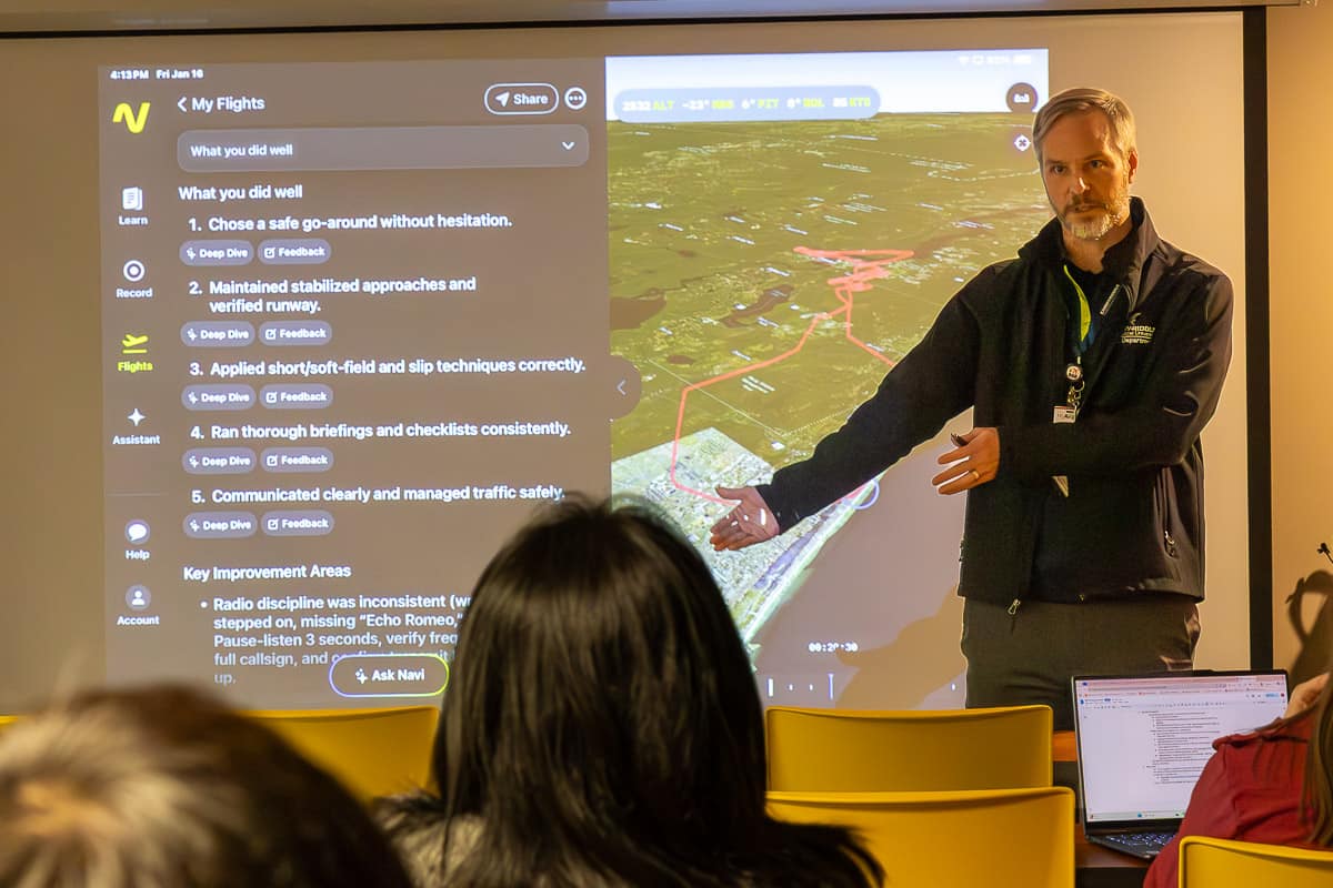 Embry-Riddle Research Coordinator Andrew Schneider in front of projector showing Navi AI interface.