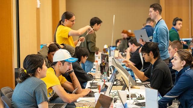 A row of students in front of computers for a aviation-focused capture-the-flag competition.
