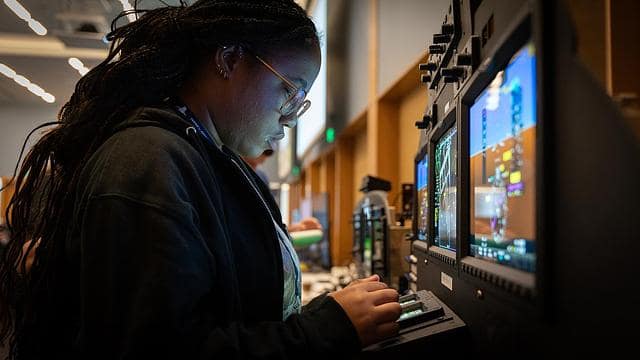 Student interacts with an avionics test bed.