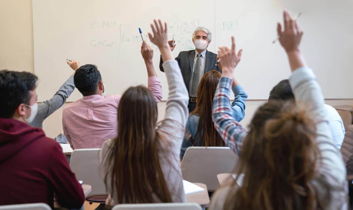 Professor teaches class with a mask on