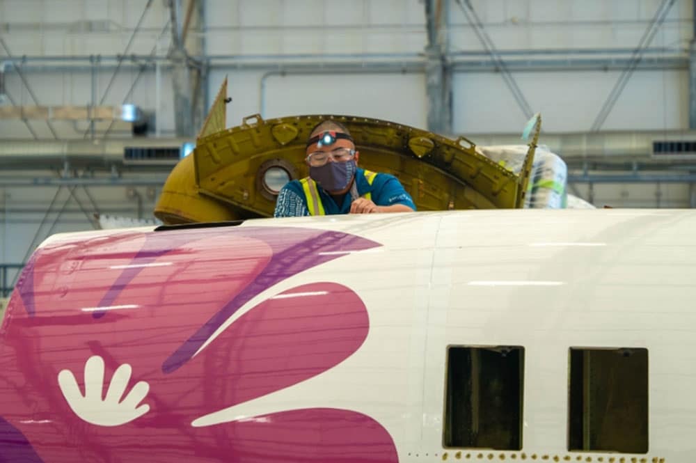 Airline employee working on plane