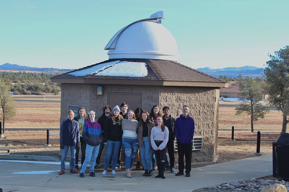 Members of the Prescott Observing Team for the Analysis of Telescopically Obtained Spectra (POTATOS) in front of the observatory