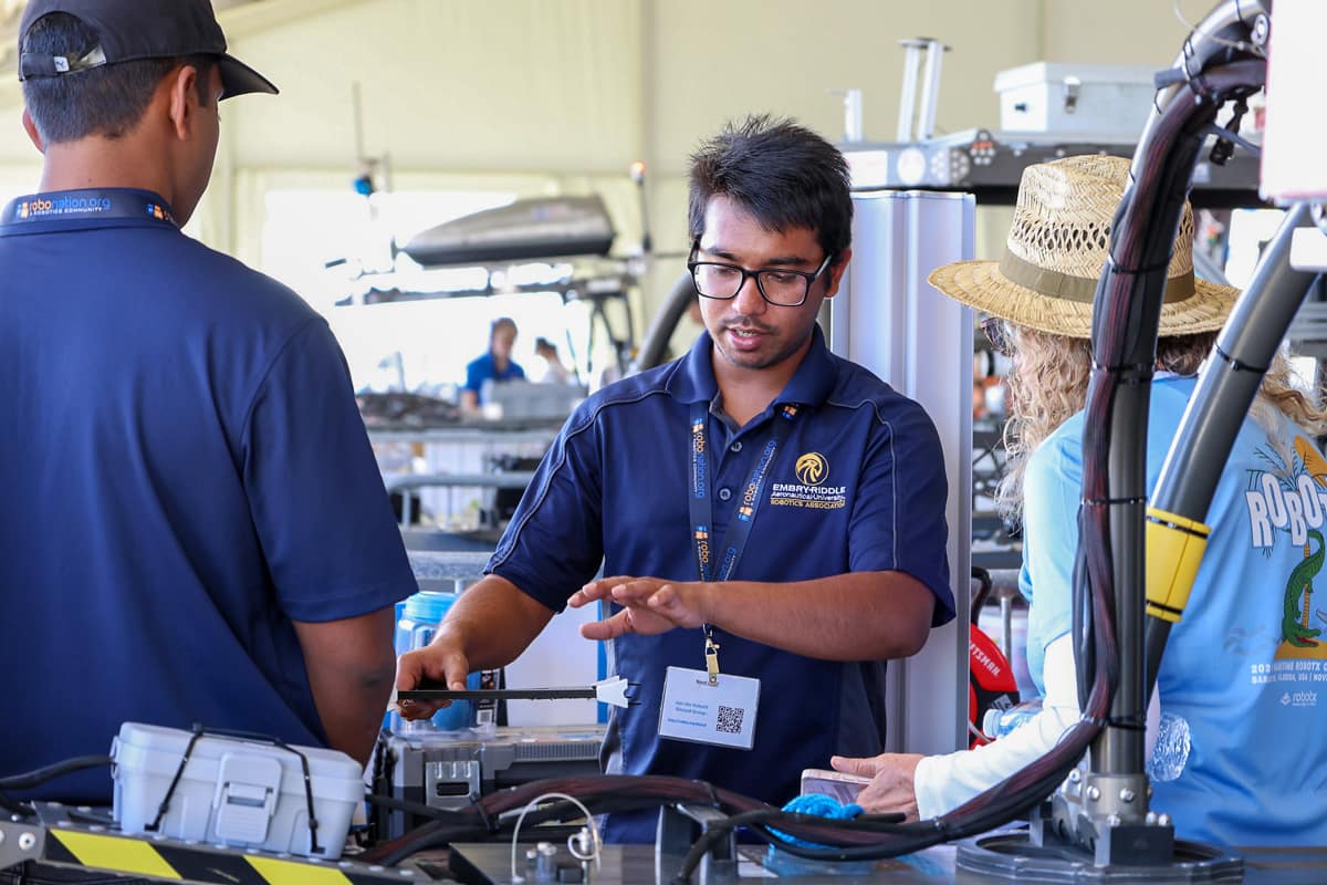 Sagar Sarkar, who is earning a Ph.D. in Mechanical Engineering, shows off equipment at the RobotX competition.