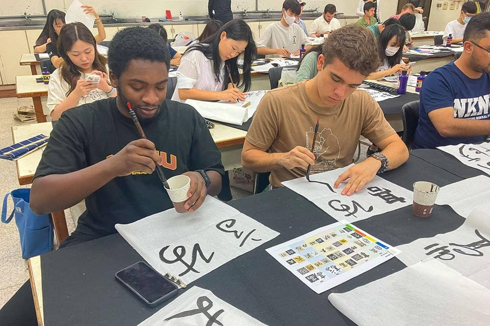 Embry-Riddle’s Project GO ROTC students practice their calligraphy as part of the language and cultural immersion program.