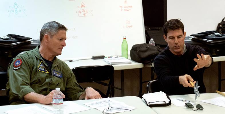 Navy Aerial Advisor Capt. Brian Ferguson works with actor Tom Cruise